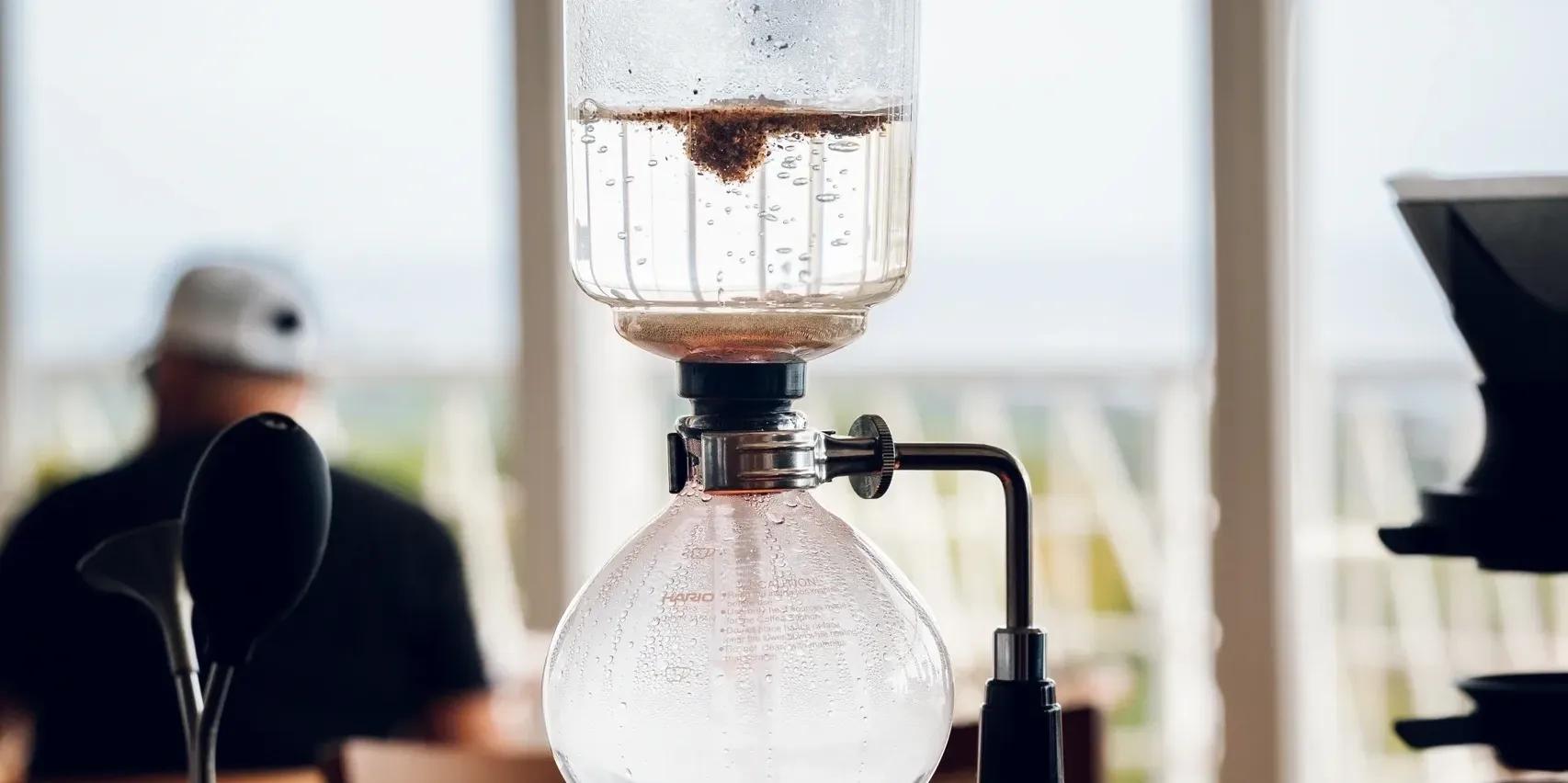 Experience specialty vacuum siphon brewing with a scenic view in Roatán.